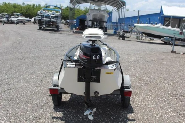 Slide: The Image of 2006 Gheenoe 13 boat with 6.0 motor on trailer in marina. - 5