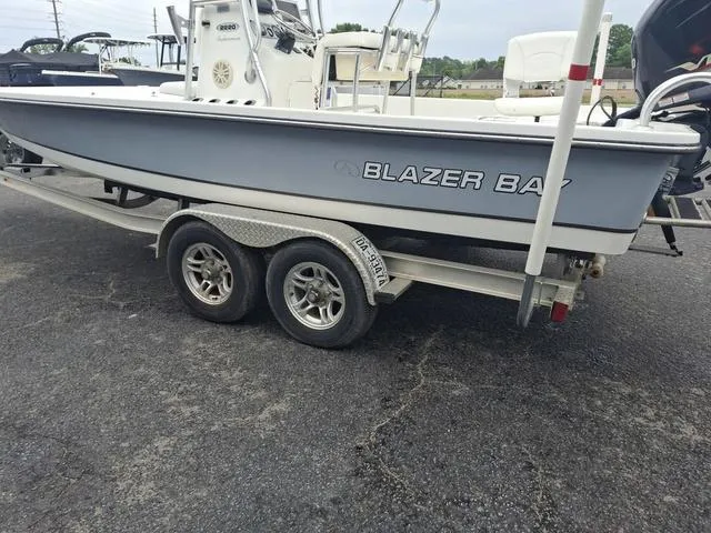 Slide: The Image of 2013 Blazer 2220 Fisherman boat on a trailer in a parking lot. - 10
