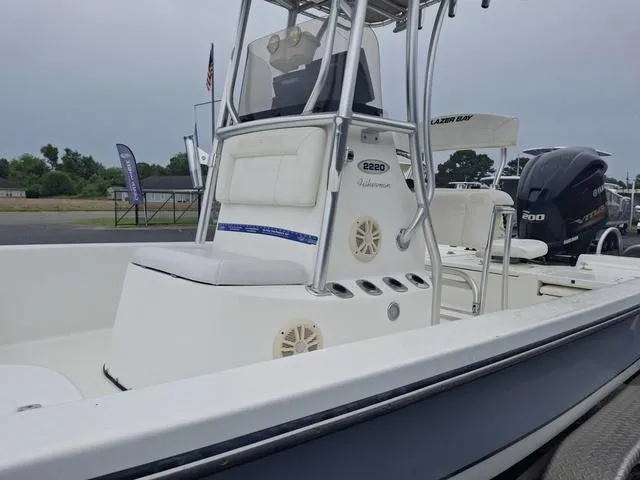 Slide: The Image of 2013 Blazer 2220 Fisherman boat with center console and outboard motor, parked outdoors. - 7