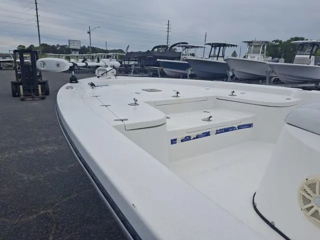 Slide: The Image of 2013 Blazer 2220 Fisherman boat displayed in a marina with other vessels. - 8