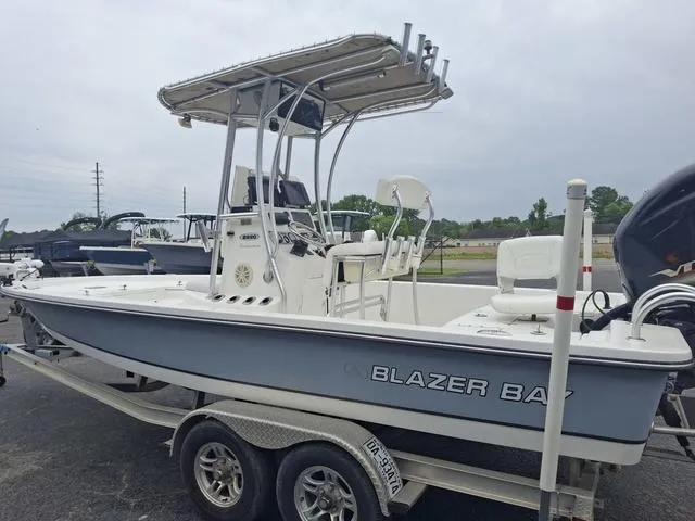 Slide: The Image of 2013 Blazer 2220 Fisherman boat on trailer, featuring T-top and center console. - 9