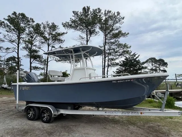 Slide: The Image of 2022 Parker 2300 SE boat on trailer, parked outdoors near trees. - 1