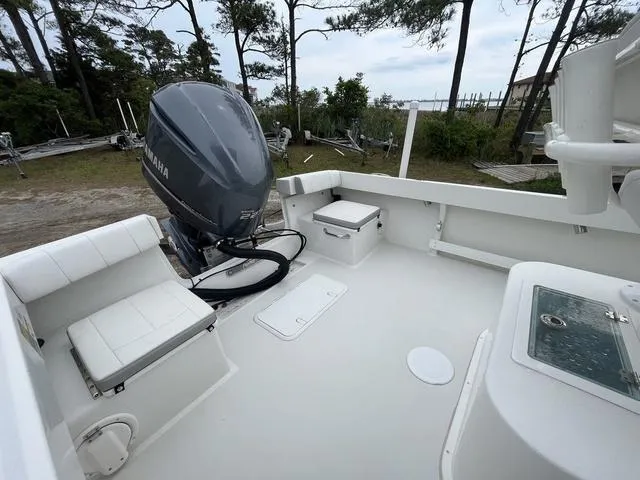 Slide: The Image of 2022 Parker 2300 SE boat with Yamaha outboard motor, spacious deck, and seating area. - 11