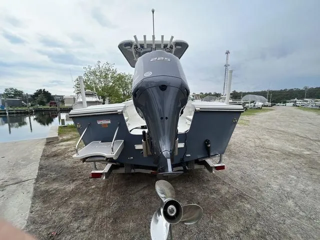 Slide: The Image of 2022 Parker 2300 SE boat with powerful outboard motor, parked near a waterfront. - 5
