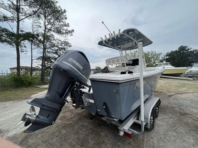 Slide: The Image of 2022 Parker 2300 SE boat with Yamaha engine on trailer, parked outdoors. - 6