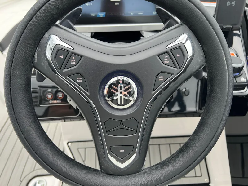 Slide: The Image of Steering wheel of 2025 Yamaha Boats 252SD with integrated controls. - 14