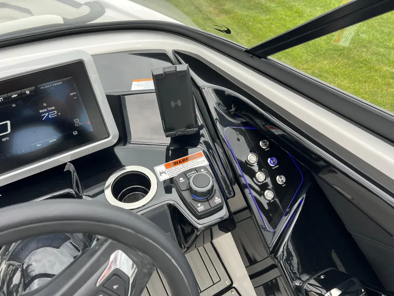 Slide: The Image of 2025 Yamaha Boats 252SD dashboard with touchscreen, controls, and phone holder. - 15