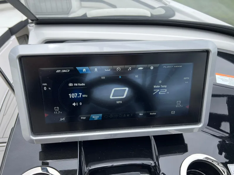 Slide: The Image of Dashboard display of 2025 Yamaha Boats 252SD, showing radio and water temperature. - 16