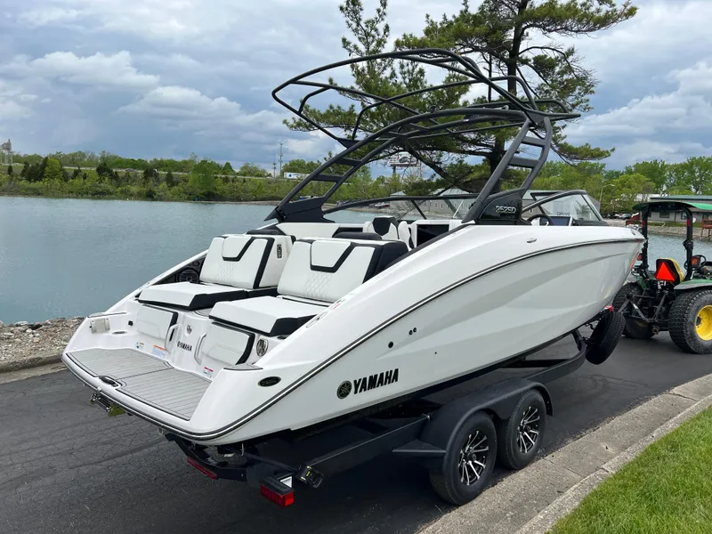 Slide: The Image of 2025 Yamaha Boats 252SD on trailer by a scenic lake. - 4