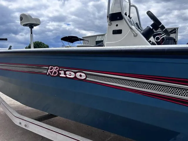 Slide: The Image of 2017 Ranger RB190 boat with blue hull and red accents under cloudy sky. - 4