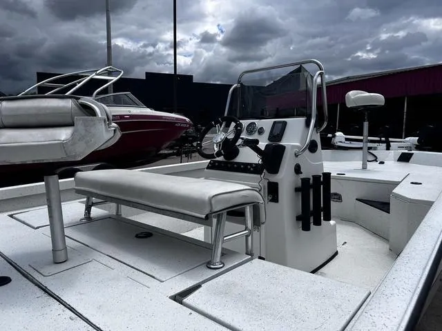 Slide: The Image of 2017 Ranger RB190 boat interior with steering console and seating under cloudy sky. - 7
