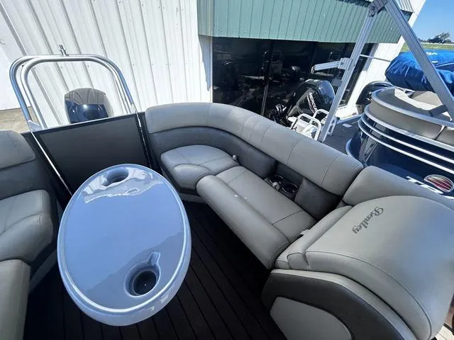 Slide: The Image of 2019 Bentley Pontoons 223 Bentley Elite Admiral with gray seating and table, docked near other boats. - 17