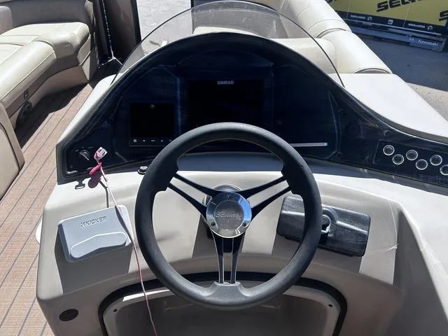 Slide: The Image of 2019 Bentley Pontoons 223 Bentley Elite Admiral dashboard with steering wheel and controls. - 20