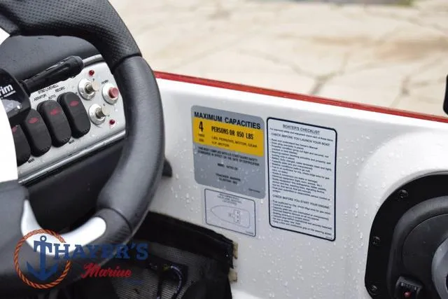 Slide: The Image of Steering wheel and control panel of 2015 Nitro Z Series Z-8 boat, showing capacity and safety labels. - 20