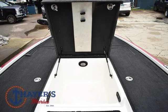 Slide: The Image of Open storage compartment on 2015 Nitro Z Series Z-8 boat, with visible interior and surrounding deck. - 25