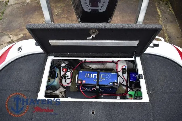 Slide: The Image of Open storage compartment of 2015 Nitro Z Series Z-8 boat showing battery and wiring. - 38