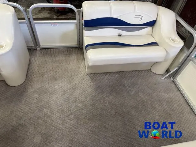 Slide: The Image of 2005 Bennington 186L Pontoon interior with white and blue seating, carpeted floor. - 11