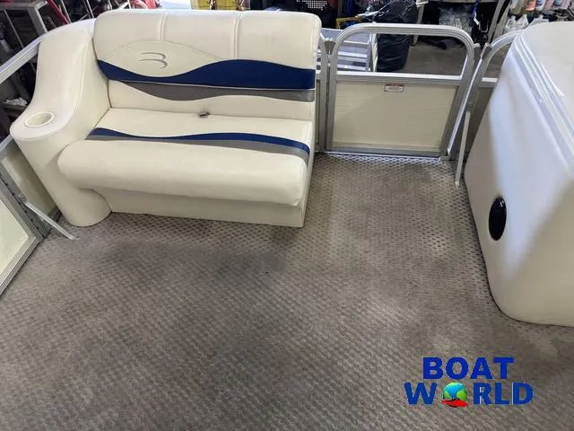 Slide: The Image of 2005 Bennington 186L Pontoon interior with beige seating and blue accents. - 13