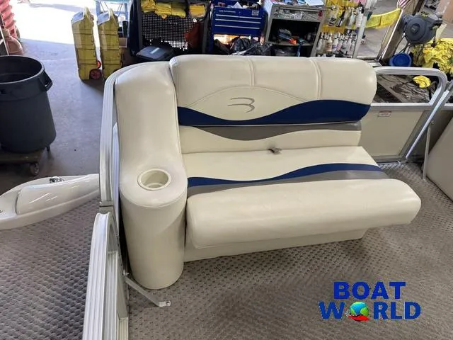 Slide: The Image of 2005 Bennington 186L Pontoon seat with blue accents in a workshop setting. - 14