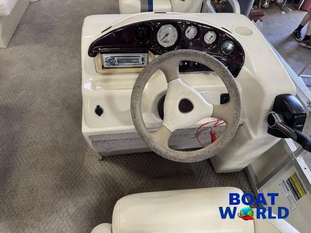 Slide: The Image of 2005 Bennington 186L Pontoon boat dashboard with steering wheel and control panel. - 18