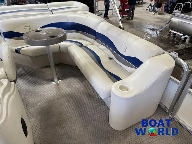 Slide: The Image of 2005 Bennington 186L Pontoon boat interior with white and blue seating and table. - 22