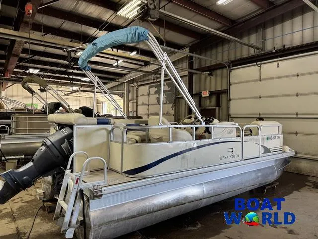 Slide: The Image of 2005 Bennington 186L Pontoon boat in a warehouse, featuring a covered canopy. - 26