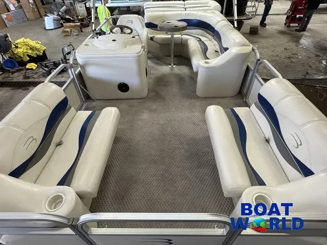 Slide: The Image of 2005 Bennington 186L Pontoon boat interior with white seating and blue accents. - 3