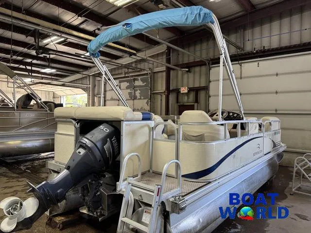 Slide: The Image of 2005 Bennington 186L Pontoon boat in a warehouse, featuring a Yamaha outboard motor. - 38
