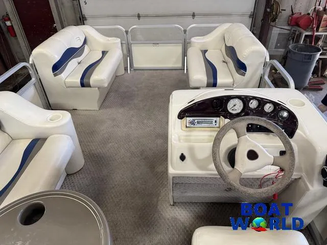 Slide: The Image of Interior of a 2005 Bennington 186L Pontoon boat with seating and steering console. - 6