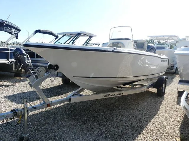 Slide: The Image of 2025 Key West 203 FS boat on trailer, parked outdoors in a gravel lot. - 3