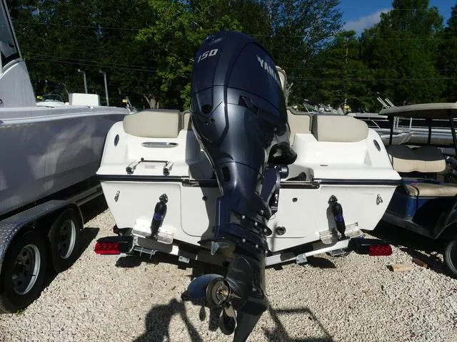 Slide: The Image of 2025 Key West 203 FS boat with Yamaha 150 outboard motor, parked on gravel. - 5