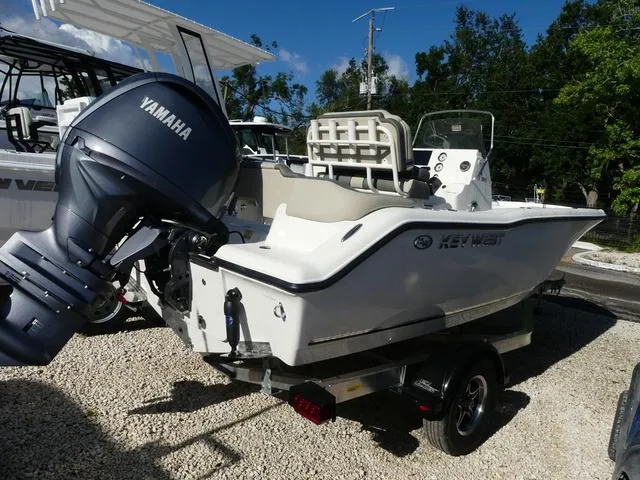 Slide: The Image of 2025 Key West 203 FS boat with Yamaha engine on a trailer, parked outdoors. - 6