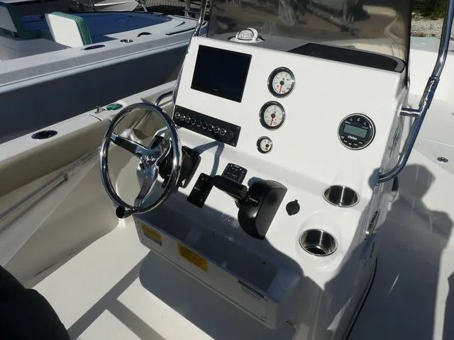 Slide: The Image of 2025 Key West 203 FS boat console with steering wheel, gauges, and controls. - 7