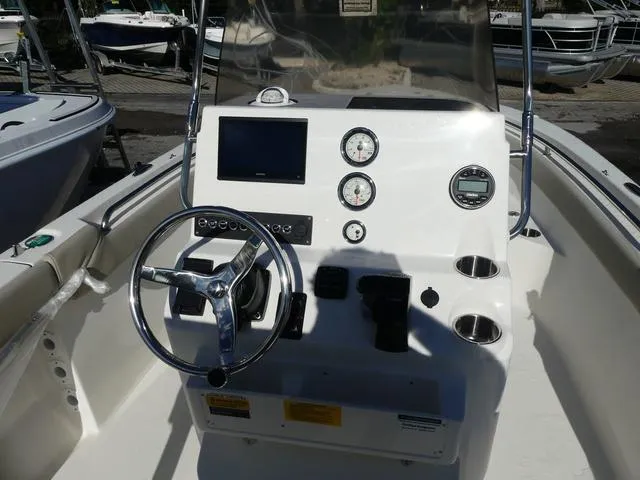Slide: The Image of 2025 Key West 203 FS boat dashboard with steering wheel and gauges. - 8