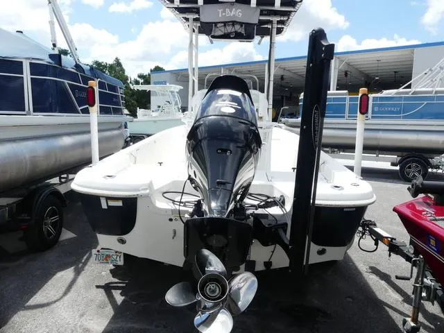 Slide: The Image of 2013 NauticStar 1910 NauticBay boat with outboard motor, parked at a marina. - 4