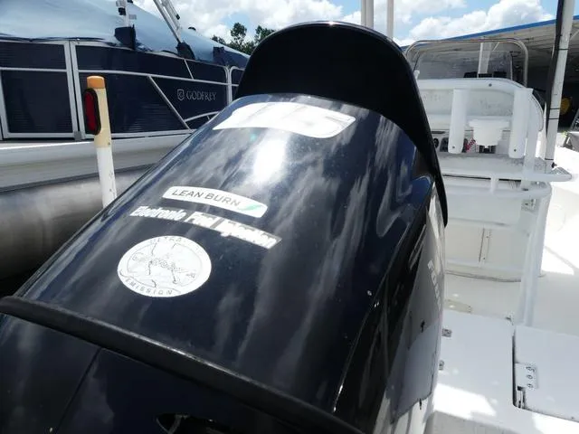 Slide: The Image of 2013 NauticStar 1910 NauticBay boat with electronic fuel injection engine, docked outdoors. - 5