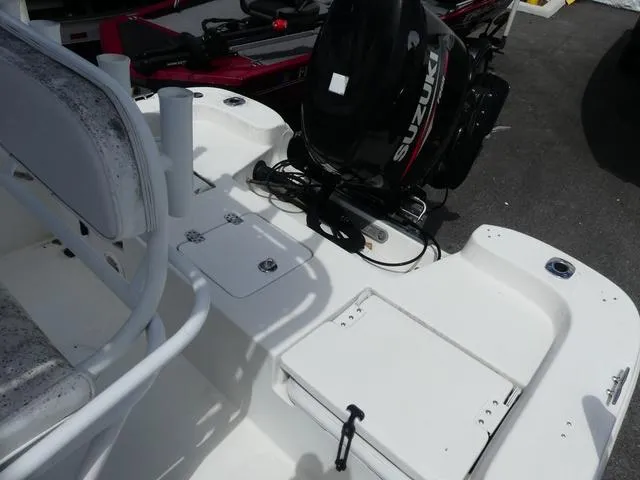 Slide: The Image of 2013 NauticStar 1910 NauticBay boat with Suzuki outboard motor, white deck, and seating area. - 9