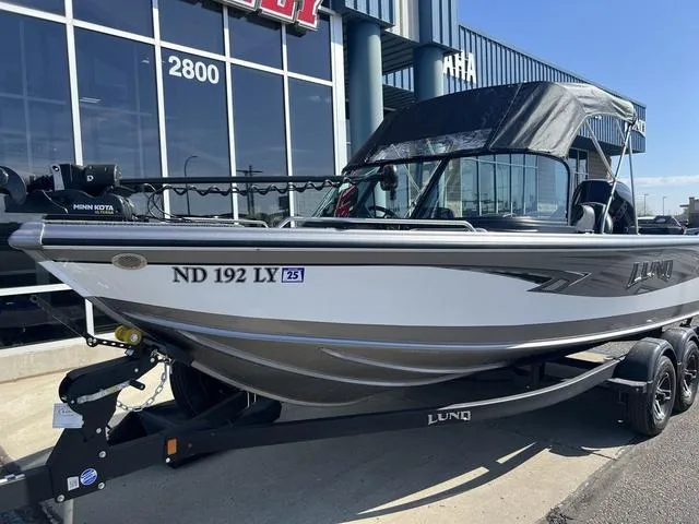 Slide: The Image of 2023 Lund 1975 Tyee Sport boat on trailer, parked outside dealership. - 12