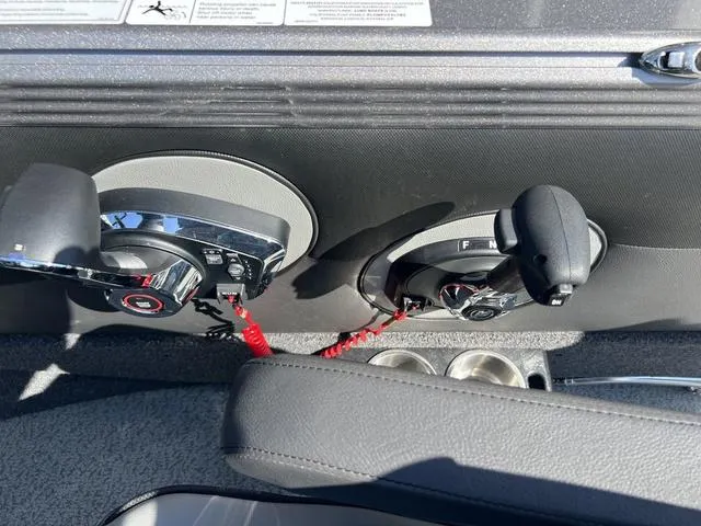 Slide: The Image of Control panel of 2023 Lund 1975 Tyee Sport boat with dual throttle levers. - 21