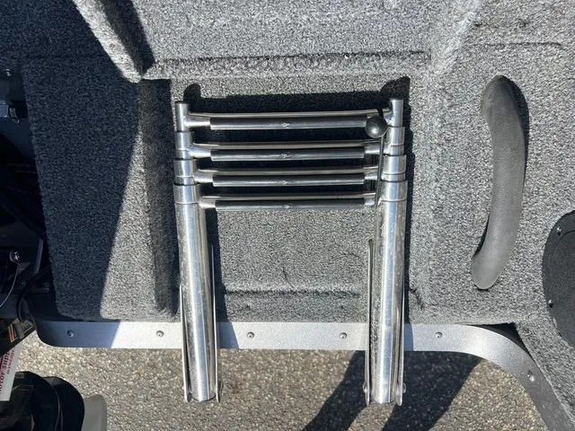 Slide: The Image of Folded metal ladder on a 2023 Lund 1975 Tyee Sport boat deck. - 24