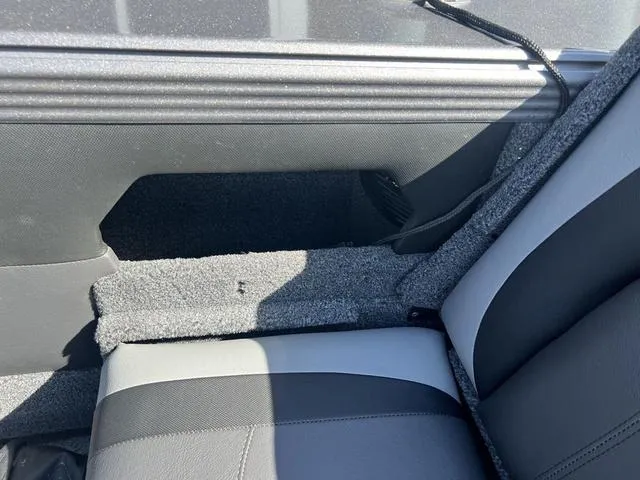 Slide: The Image of Interior of 2023 Lund 1975 Tyee Sport boat, featuring gray and black seating. - 25