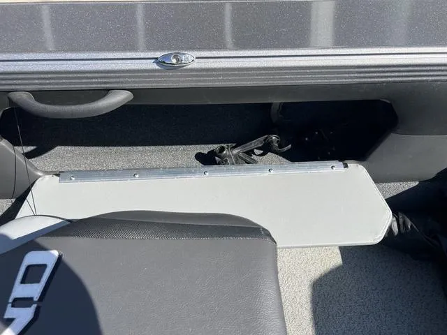 Slide: The Image of Interior of 2023 Lund 1975 Tyee Sport boat, featuring seating and storage compartment. - 26