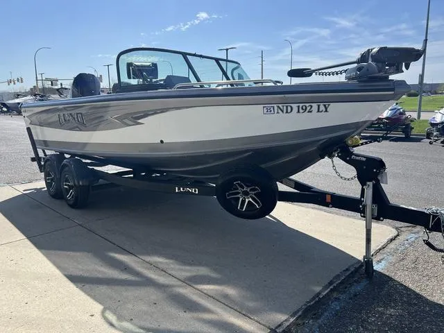 Slide: The Image of 2023 Lund 1975 Tyee Sport boat on trailer, parked outdoors in daylight. - 3