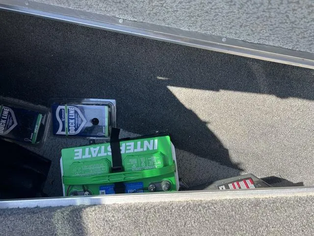 Slide: The Image of Storage compartment in a 2023 Lund 1975 Tyee Sport boat with battery and accessories. - 34