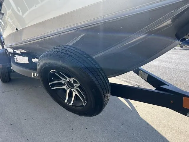 Slide: The Image of Trailer wheel of a 2023 Lund 1975 Tyee Sport boat on pavement. - 4