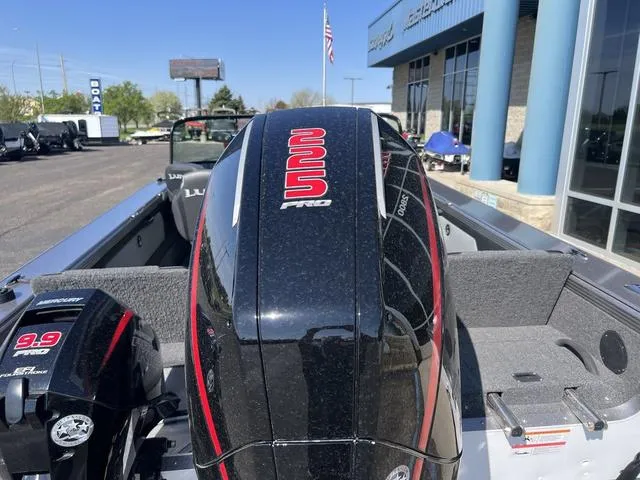 Slide: The Image of 2023 Lund 1975 Tyee Sport boat with dual outboard motors at dealership. - 6