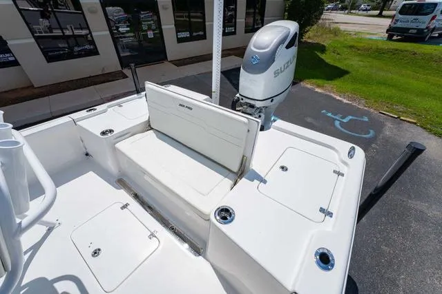 Slide: The Image of 2025 Sea Pro 250 Bay boat with Suzuki outboard motor, featuring spacious deck and storage compartments. - 11