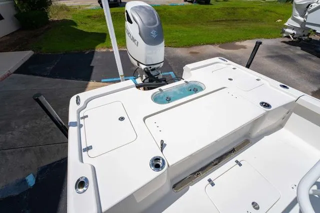 Slide: The Image of 2025 Sea Pro 250 Bay boat with Suzuki outboard motor, featuring spacious deck and storage compartments. - 12