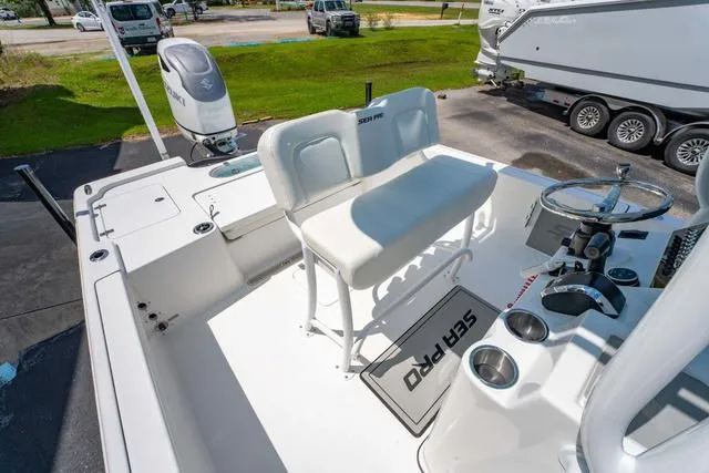 Slide: The Image of 2025 Sea Pro 250 Bay boat interior with seating and steering wheel. - 13