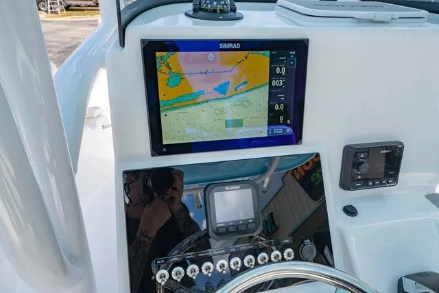 Slide: The Image of 2025 Sea Pro 250 Bay boat dashboard with navigation and control systems. - 17
